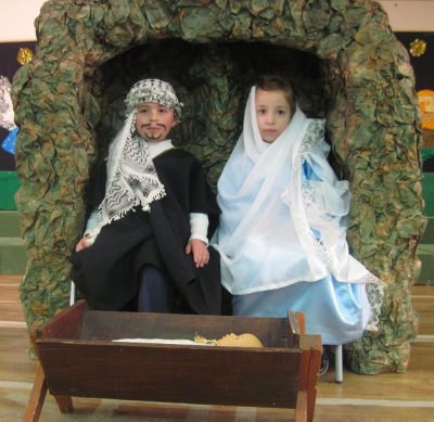 A photo of two children dressed as Mary and Joseph in the nativity.