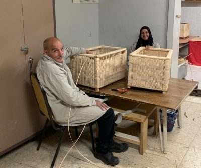 A teacher patiently sits and works with deaf student