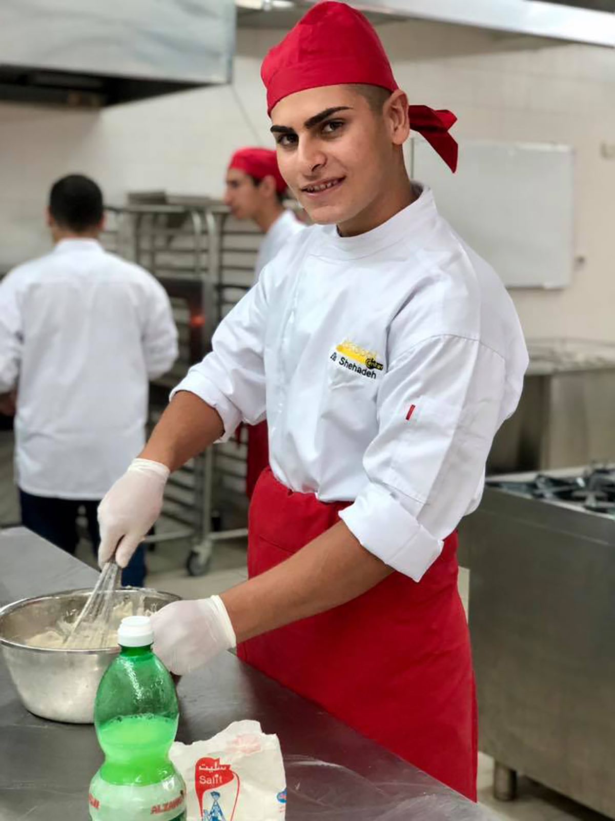 A photo of a young chef working in kitchen at ETVTC, Ramallah, West Bank