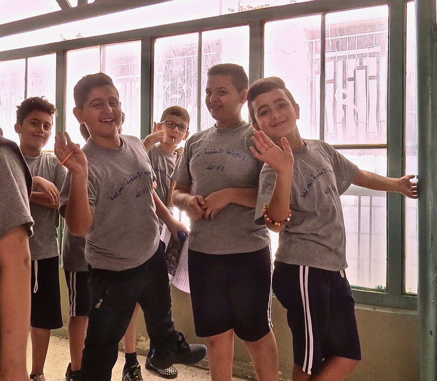 A photo of boys waving at the Arab Evangelical School in Ramallah