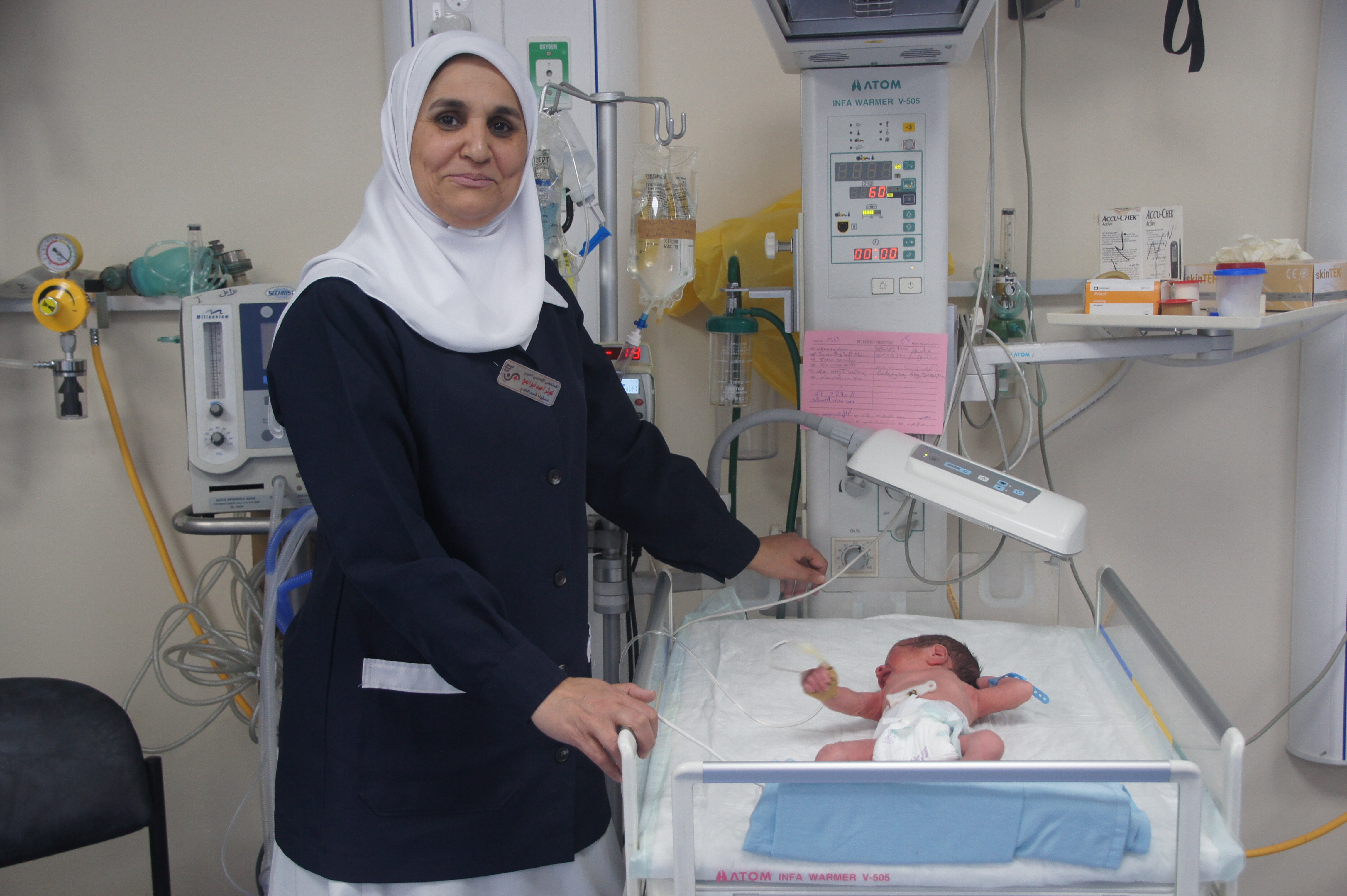 A photo of a nurse smiling at St. Luke's Hospital West Bank, Palestine.