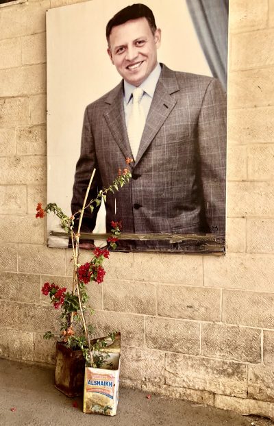 A photo of a portrait of King of Jordan, Abdallah al-Thani bin al-Hussein beside the entrance to St. Saviour's School.