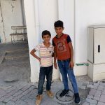 A photo of two boys standing outside Ahli Arab Hospital.