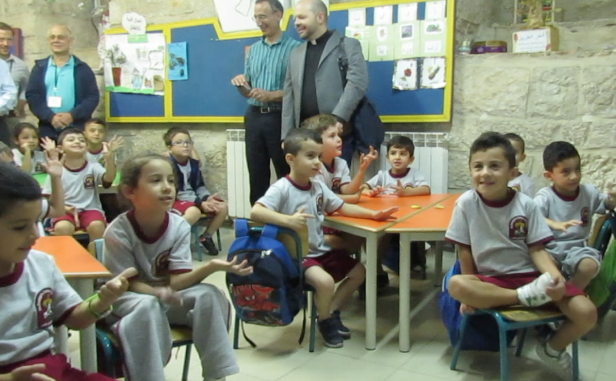 A photo of young elementary boys and girls in classroom at Palestinian school, St. George's.