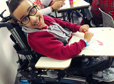 A photo of a boy in a wheelchair