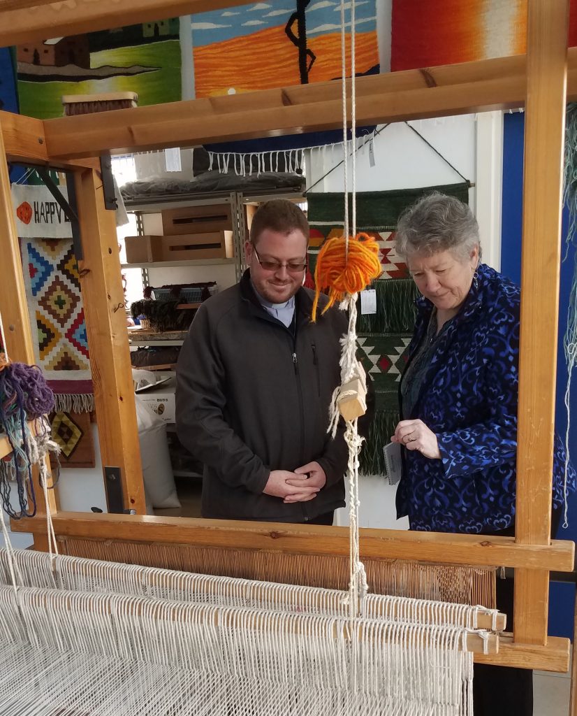 Fr. Wadie Far of HLID shows Doni Heyn-Lamb the looms used by vocational students at Holy Land Institute for the Deaf