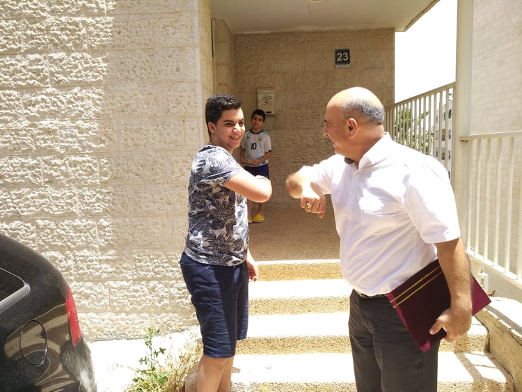 Door-to-door diploma delivery for Arab Evangelical Episcopal School seniors